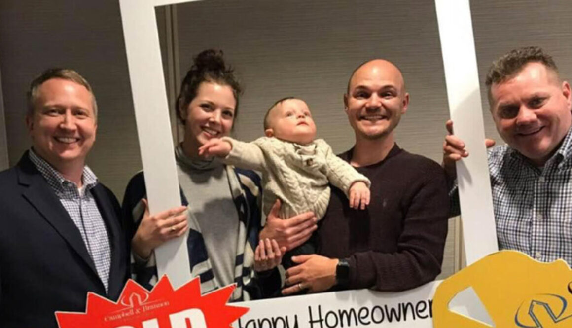 Realtor Richard Beeman with new home owners Katie and Dean Atkins and their child