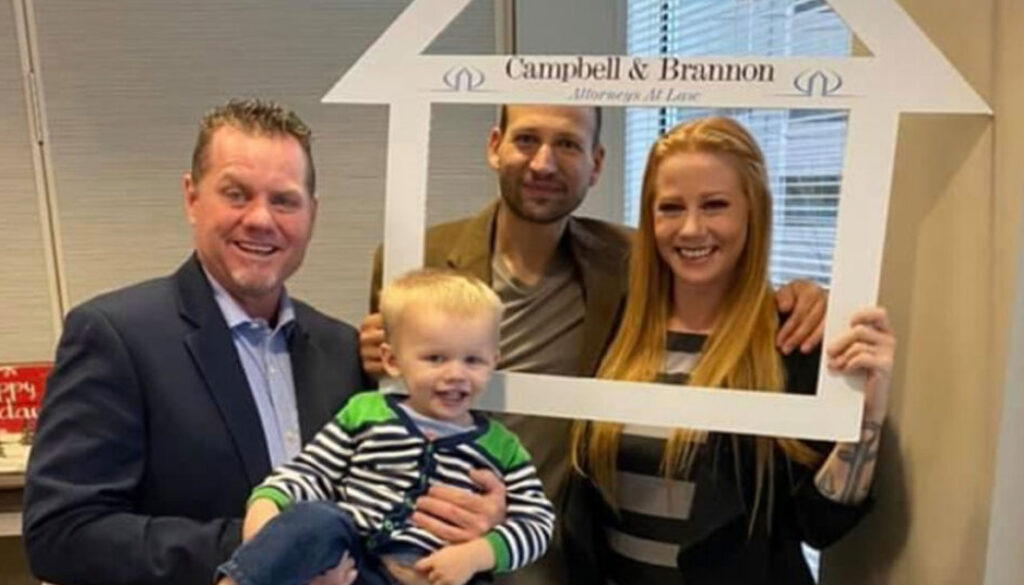 Realtor Richard Beeman with home owners Jon and Melissa De Meglio and their son