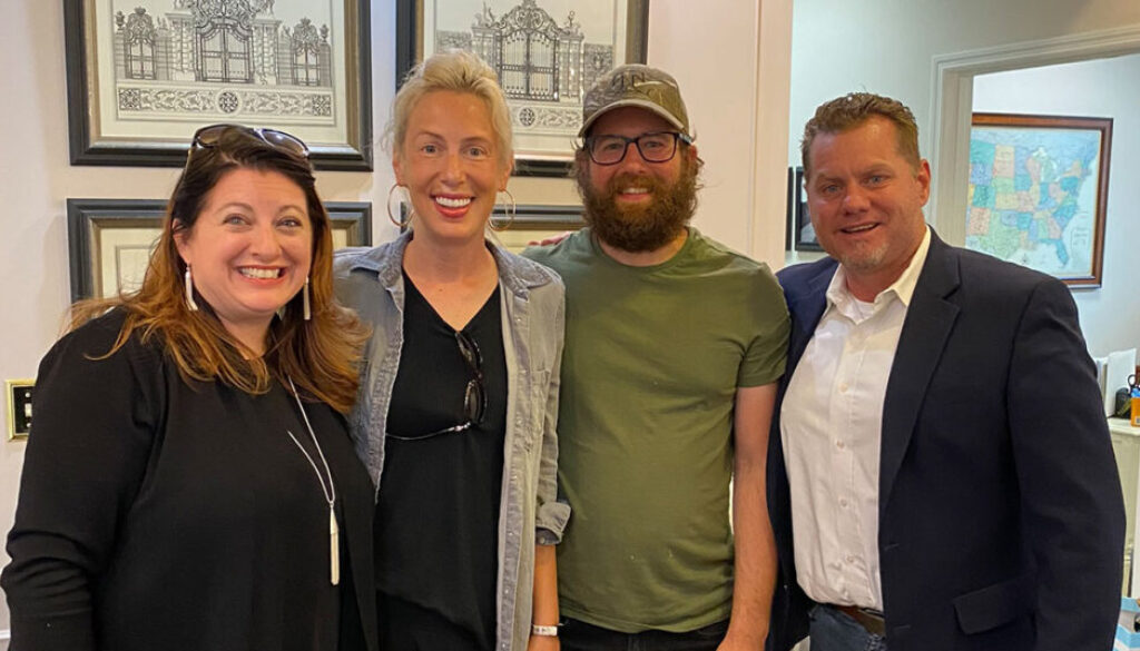 Chief Operating Officer Trish Beeman and Realtor Richard Beeman with home owners Shannon and Sam Chimento